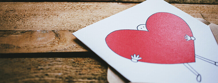 Greeting card of a cartoon person and a heart