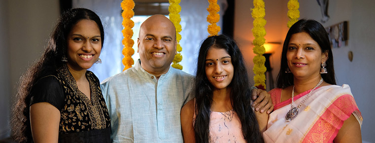 Balaji Ponnuswamy with his daughters, Varsha (left), Priyanka (center right) and his wife, Gayathri (right).