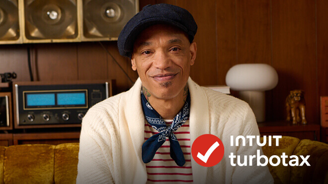 A man wearing a hat and a white cardigan. Intuit TurboTax logo.