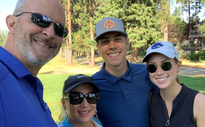 An image of Shawna Thompson with her family on a golf course. From left to right: her husband, Derek, Shawna, her son, Drew, and her daughter, Shaylee.