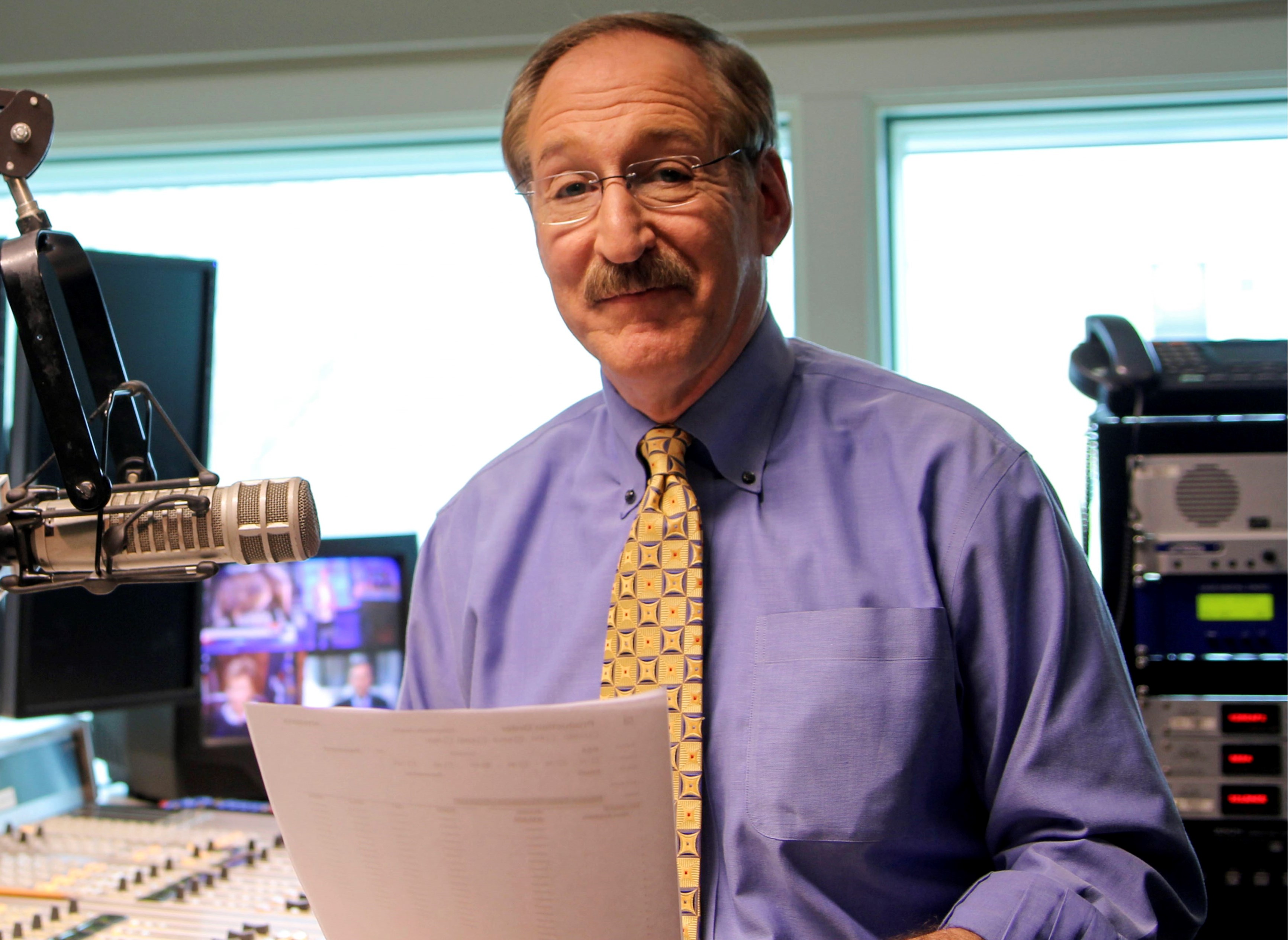 News reporter Herb Weisbaum holding a radio script