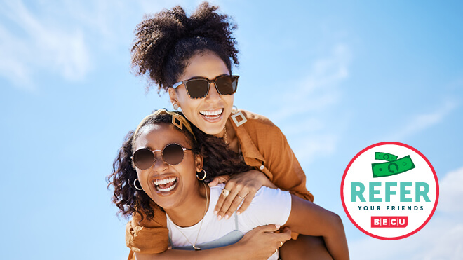 Two smiling women wearing sunglasses and the BECU Refer A Friend logo.